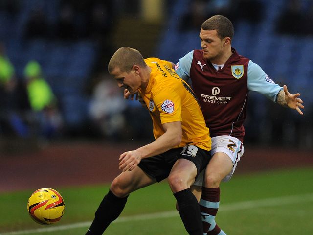 Burnley's Kieran Trippier holds up Barnsley's Tomasz Cywka