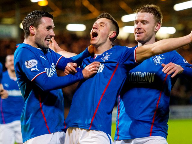 Fraser Aird (centre) celebrates having opened the scoring