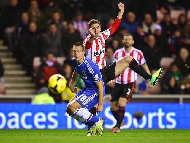 Cesar Azpilicueta tries to block a shot from Fabio Borini