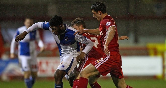 Ellis Harrison: Is tackled by Crawley's Billy Clarke (c) and Joe Walsh (r)