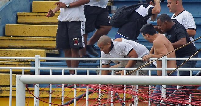 Vasco da Gama fans attack an Atletico Paranaense supporter