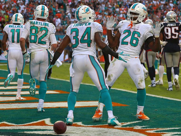 Marcus Thigpen and Lamar Miller celebrate for the Dolphins