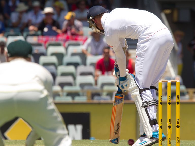 Stuart Broad picks up his foot injury as he falls lbw to Johnson