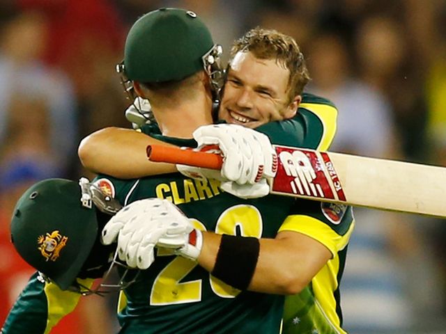 Aaron Finch celebrates his century with skipper Michael Clarke