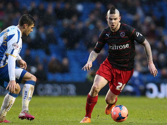 Danny Guthrie of Reading runs at the Brighton defence
