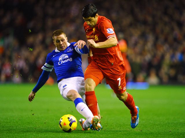 Luis Suarez skips past a challenge from James McCarthy