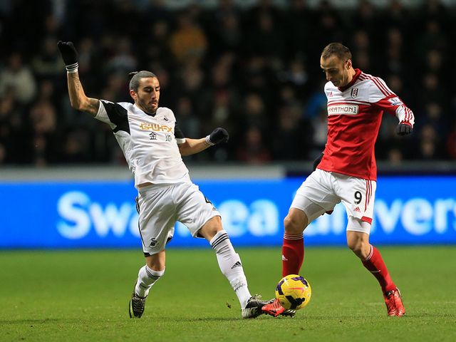 Chico and Dimitar Berbatov battle for the ball