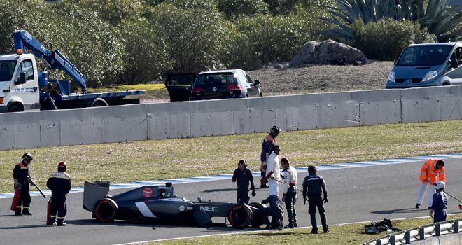 Adrian Sutil inspects his crashed car