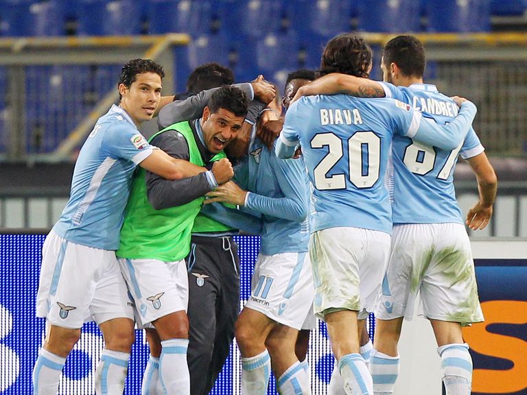 Lazio players mob Miroslav Klose after his late goal