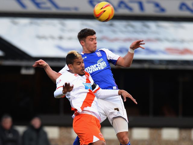 Aaron Cresswell of Ipswich Town challenges Fari Haroun of Blackpool