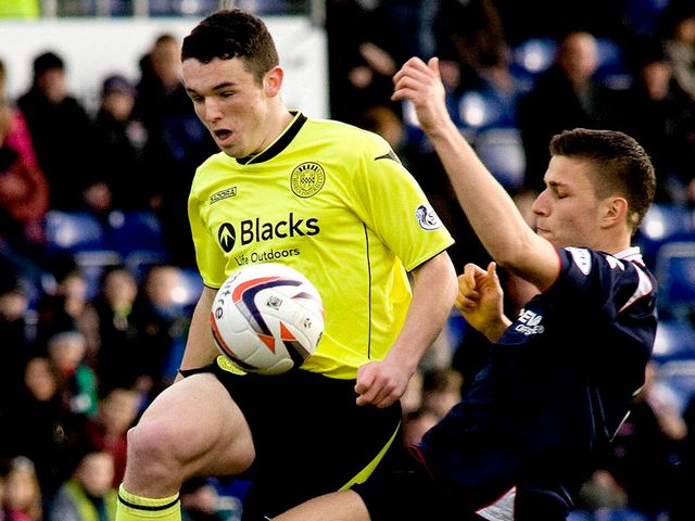 John McGinn is challenged by Filip Kiss