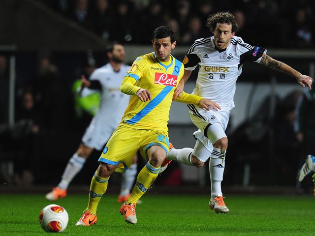 Swansea's Jose Canas challenges Blerim Dzemaill of Napoli