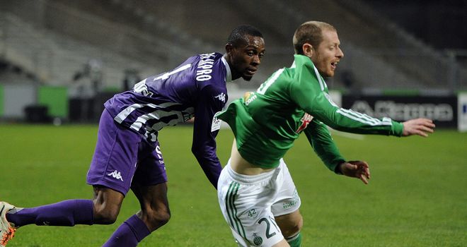 Akpro vies for the ball with Jonathan Brison