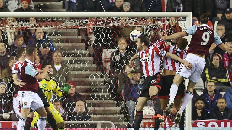 Andy Carroll: Leaps above John O'Shea to head West Ham into the lead