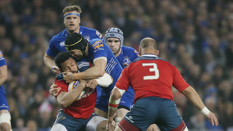 Munster's Casey Laulala tangles with Leinster's Kevin McLaughlin