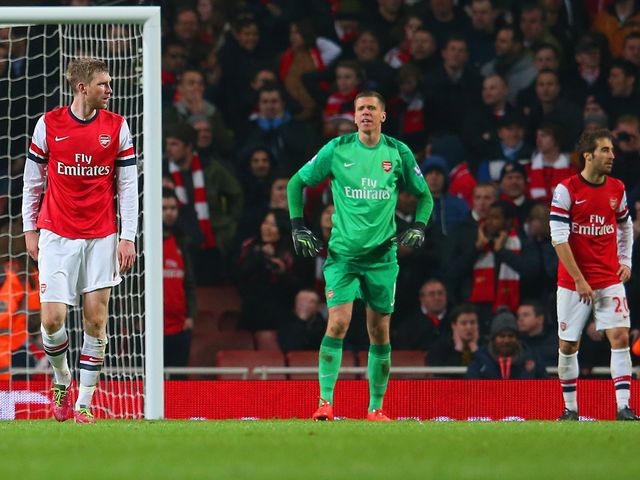 Arsenal players look dejected after the late own-goal at the Emirates Stadium