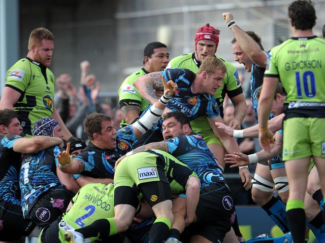 Exeter celebrate as they cross for a try against Northampton