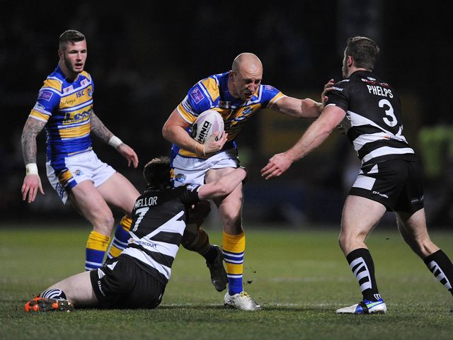 Carl Ablett is tackled by Joe Mellor and Cameron Phelps