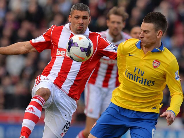 Jon Walters and Laurent Koscielny compete for the ball