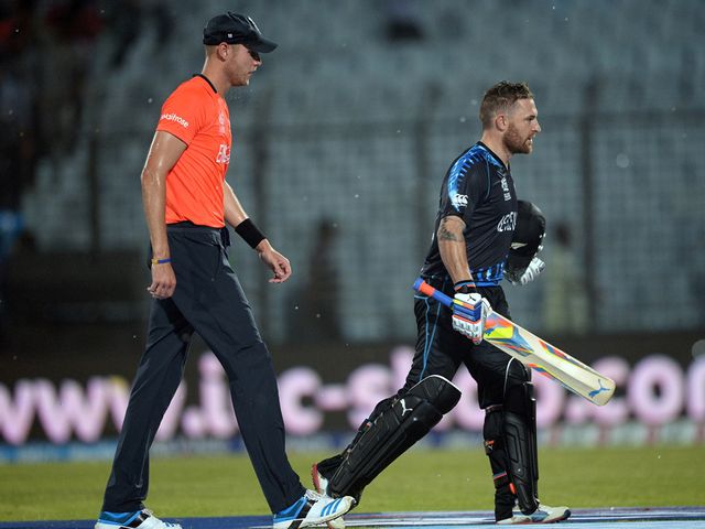 Job done: McCullum (r) heads off as the rain falls in Chittagong