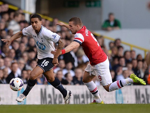 Lukas Podolski gets hold of Kyle Naughton