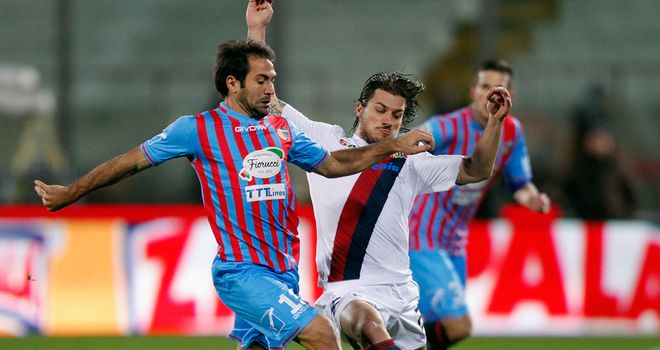 Fabian Rinaudo (left) of Catania battles with Daniele Dessena