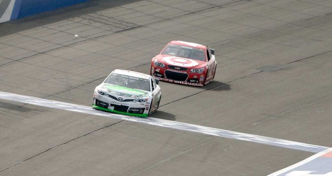 Kyle Busch leads Kyle Larson over the line to win the Auto Club 400