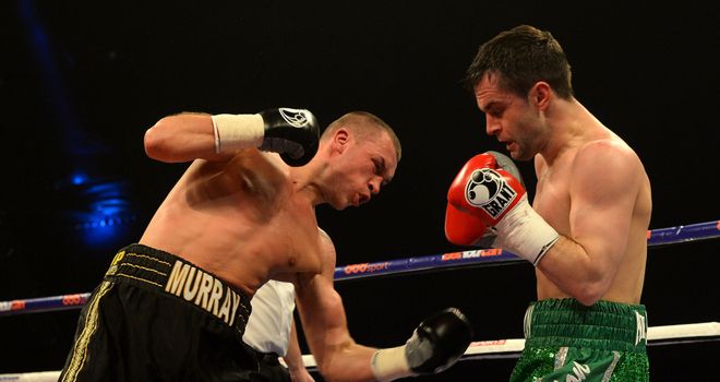 John Murray lands a crunching body shot on opponent John Simpson