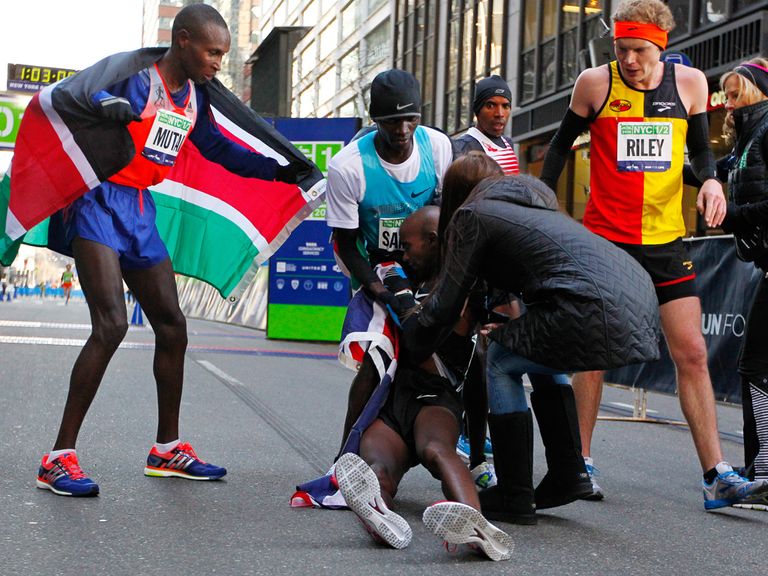 Mo Farah collapses after crossing the line in New York