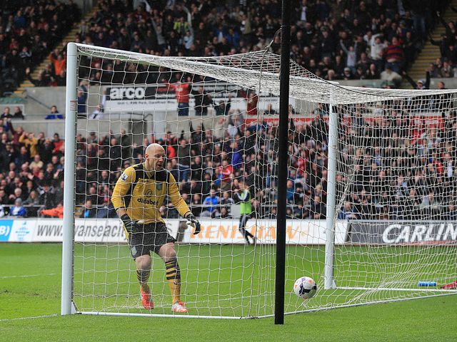 Brad Guzan looks on after Jonjo Shelvey's incredible strike drops in