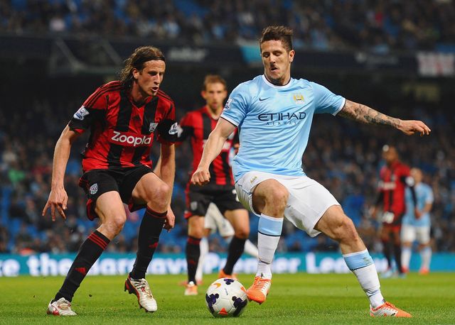 Steven Jovetic of Manchester City takes on West Brom defender Jonas Olsson