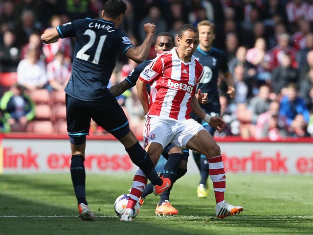 Peter Odemwingie of Stoke in action with Nacer Chadli of Tottenham