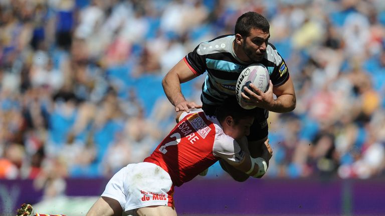 London Broncos' Maxime Herold is tackled by Catalan Dragons' Morgan Escare
