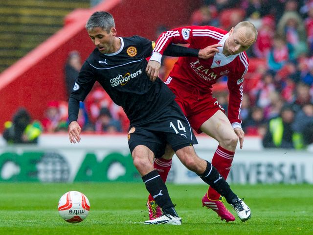 Keith Lasley is kept in check by Willo Flood