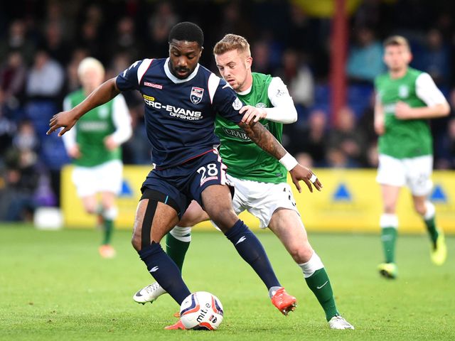 Ross County's Yann Songo'o (left) holds off Danny Handling of Hibs