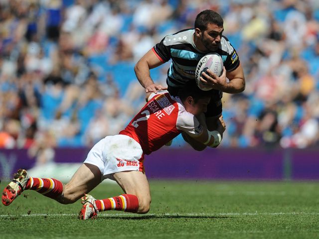 London's Maxime Herold is tackled by Catalan Dragons' Morgan Escare
