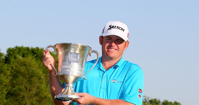 J.B. Holmes celebrates with the trophy after winning the Wells Fargo Championship