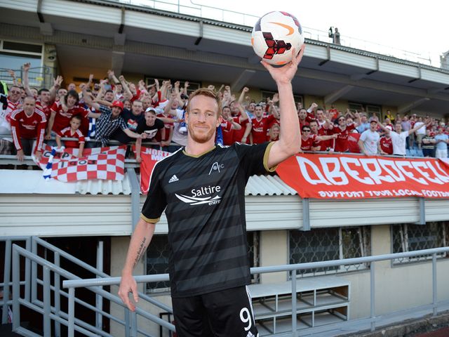 Hat-trick hero Adam Rooney celebrates with the match ball