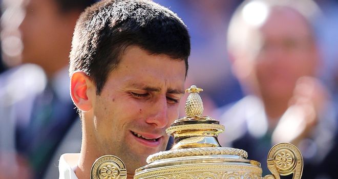 Novak Djokovic weeps whilst holding the Wimbledon trophy