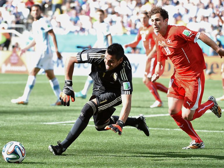 Argentina goalkeeper Sergio Romero gets to the ball ahead of Switzerland's Admir Mehmedi