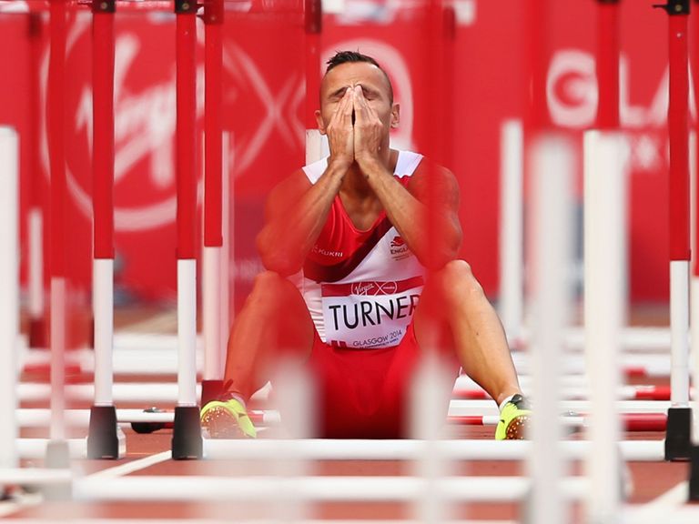 Andy Turner of England sits on the track after failing to finish