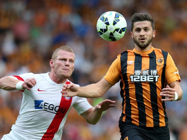 Shane Long (r) battles for the ball