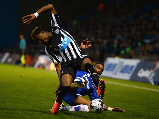 Leon Legge of Gillingham tackles Rolando Aarons of Newcastle