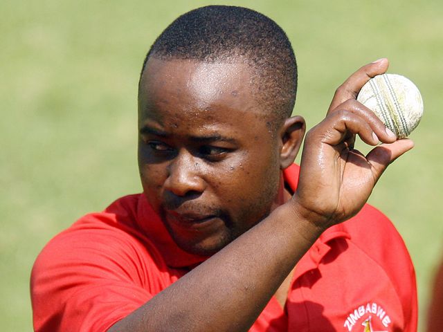 Prosper Utseya holds up the match ball after his hat-trick against South Africa