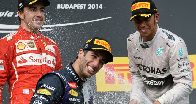 Daniel Ricciardo celebrates with Fernando Alonso and Lewis Hamilton on the Hungarian GP podium