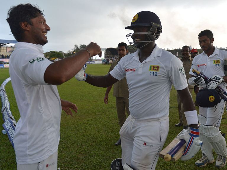 Angelo Mathews and Kumar Sangakkara celebrate after winning the first Test
