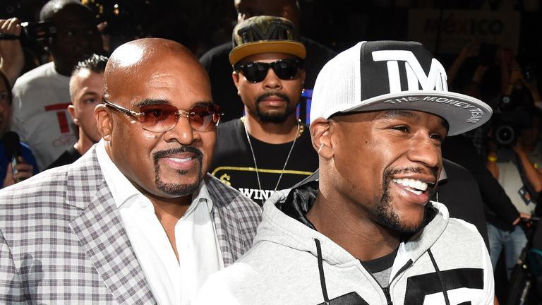 CEO of Mayweather Promotions Leonard Ellerbe (L) and WBC/WBA welterweight champion Floyd Mayweather Jr. arrive at MGM Grand