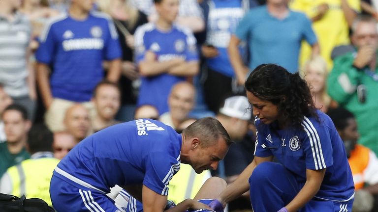 Physio Jon Fearn (left) and former club doctor Eva Carneiro (right) treat Eden Hazard in the closing moments of Chelsea's draw with Swansea