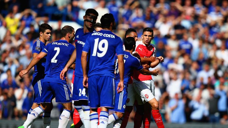 Gabriel is blocked by Chelsea players as he tries to confront Diego Costa