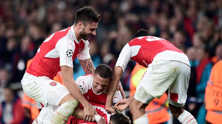Arsenal's Mesut Ozil is mobbed by team-mates